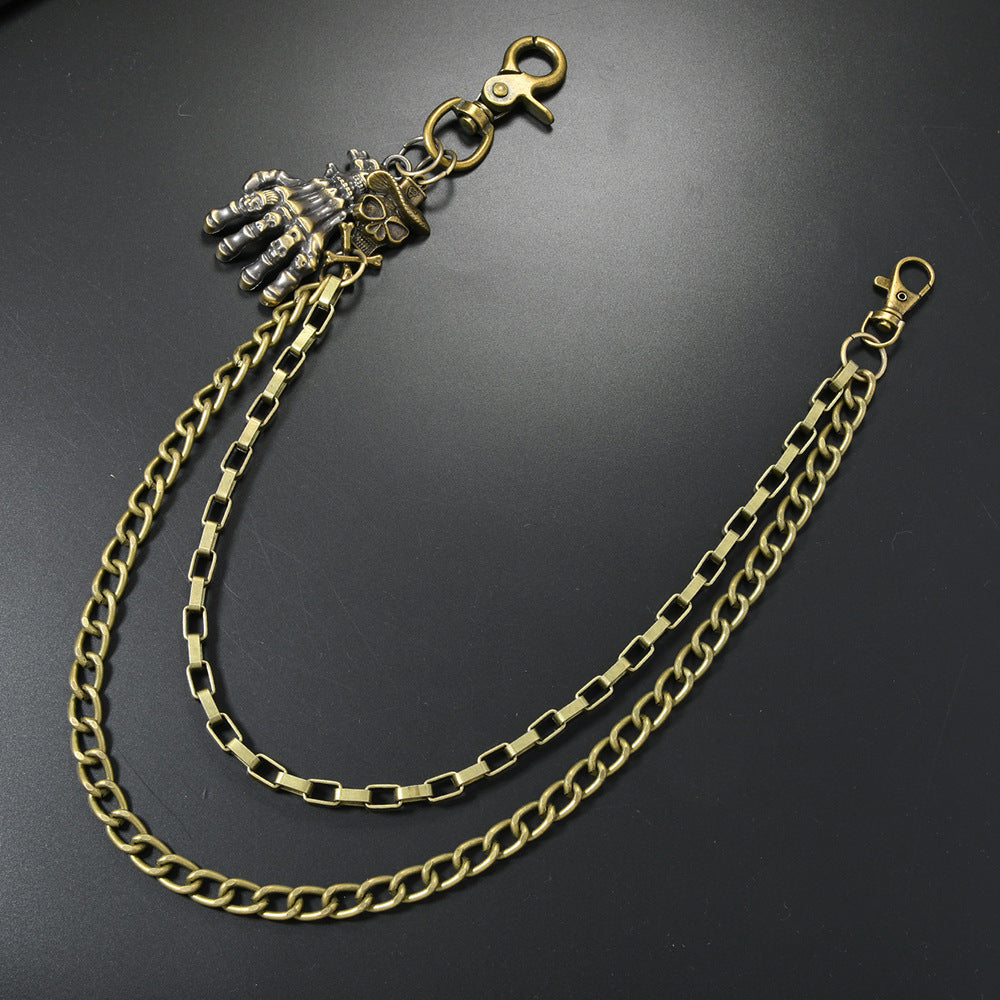 Multi-layered gold waist chain with skull pendant